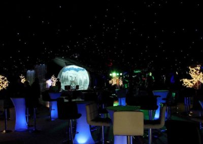 Image of Christmas party theme with lighted table bases and giant globe