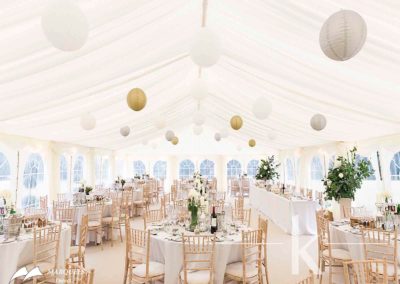 Image of wedding marquee with gold silver and white accessories and ivory paper lanterns