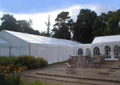 Large corporate marquee with small marquee additions situated around patio