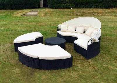 Image of Outdoor/Indoor black rattan furniture; chairs and comfort seating with cream cushions