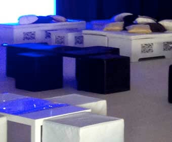 Image of white ornate island with black cube seating