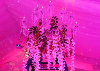 18 branch chandelier with floral accents and pink background