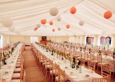 Image of long tables and brightly coloured ceiling lanterns