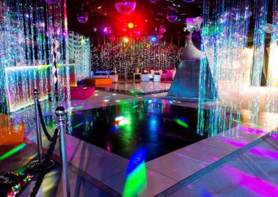Themed multi colored interior, disco floor, sparkle curtains, multi colored lighting