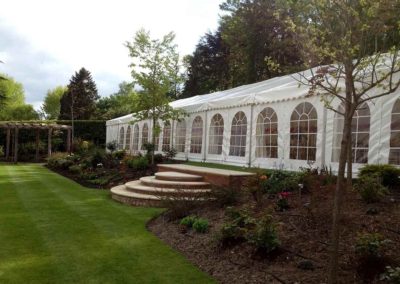 Image of wedding marquee with steps leading down to a terrace lawn